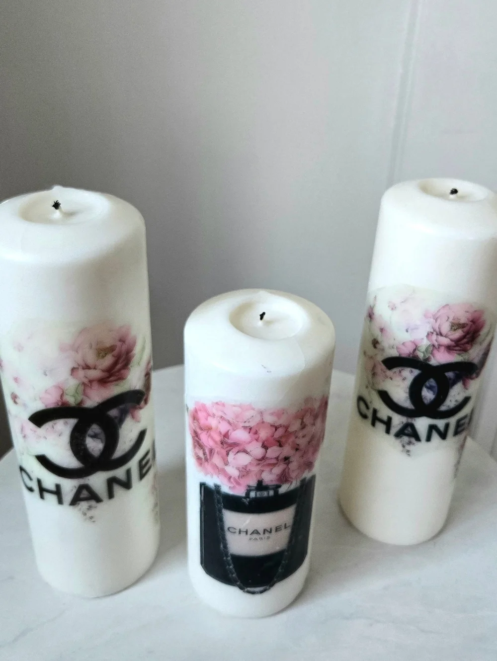 White Pillar Candles with Pink Floral Motif and Black Logo